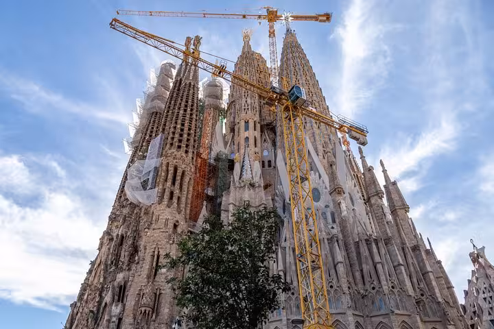 Sagrada Família basilica towers in Barcelona on guided highlights tour, Gaudí masterpiece with cranes overhead