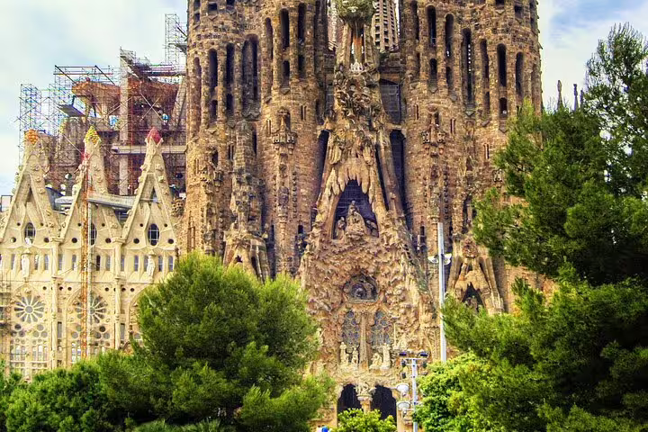 Sagrada Família ornate stone facade with tall spires and intricate carvings in Barcelona