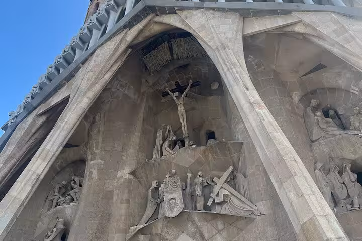 Exterior of Sagrada Familia in Barcelona displaying detailed stone carvings on the Passion facade.