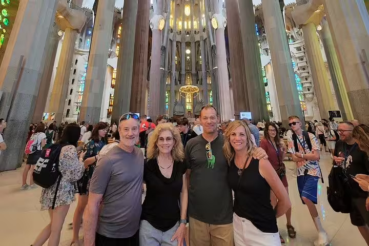 Visitors inside the stunning interior of Sagrada Familia, showcasing its architectural beauty on a Barcelona tour.