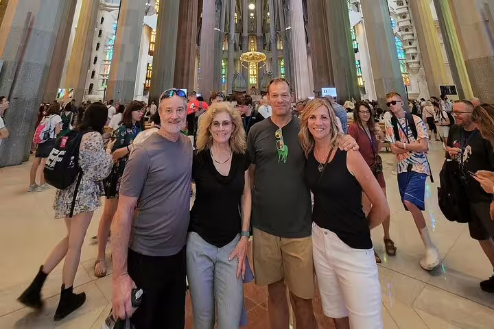A group of tourists enjoying the stunning interior of the Sagrada Familia in Barcelona, highlighting its architectural beauty.