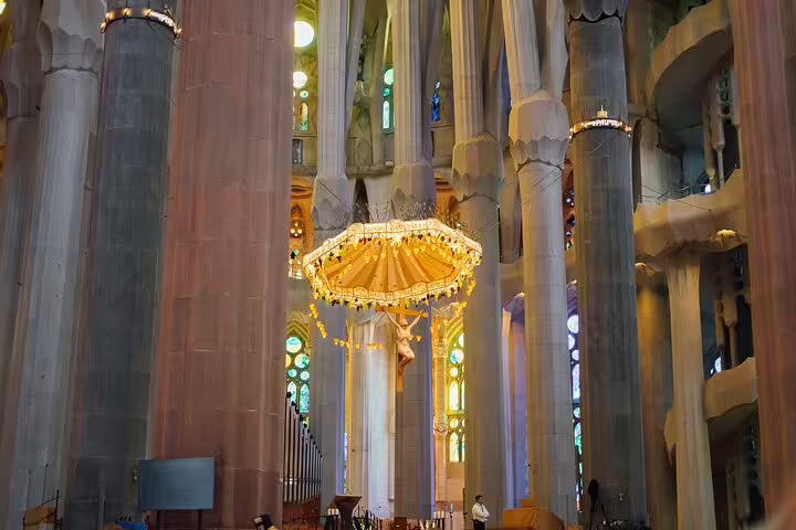 Stunning nave and altar of Sagrada Familia with vibrant stained glass, part of a skip-the-line guided experience.