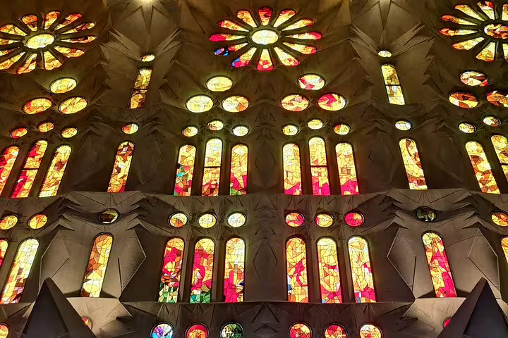 Vibrant stained glass windows of the Sagrada Familia Basilica, a highlight of the Barcelona food and drink tasting tour.