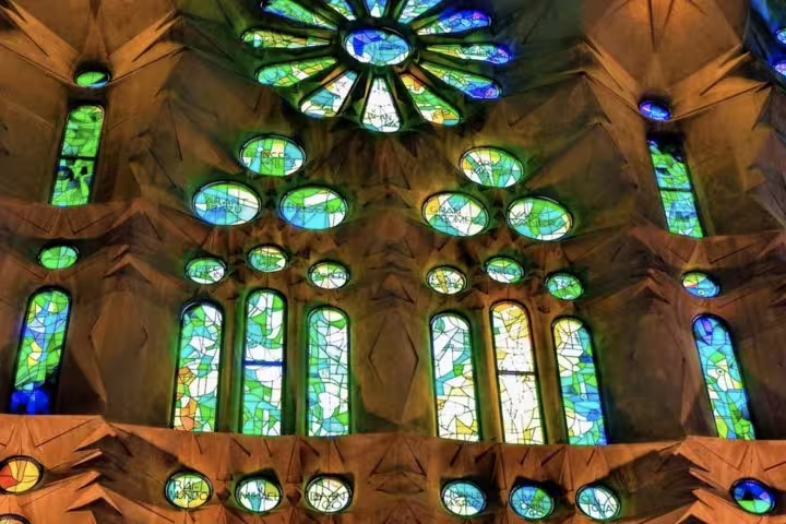 Stunning stained glass windows inside the Sagrada Familia highlight Gaudí's artistry on the Barcelona tour.
