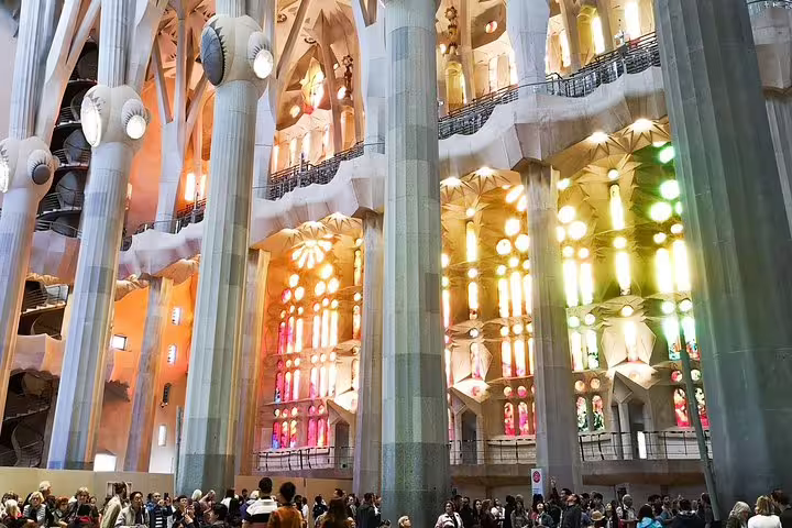 Interior view of Sagrada Familia's vibrant stained glass windows during a Barcelona private tour with tapas and Park Guell visit.