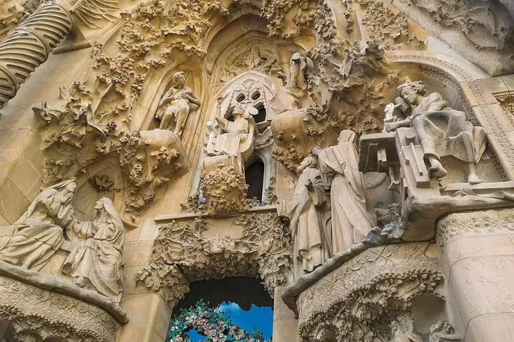 Intricate stone carvings adorn the facade of Sagrada Familia, a highlight of the Barcelona private tour with Park Guell and tapas.