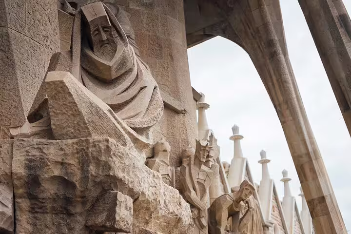 Detailed stone sculptures on Sagrada Familia's facade, highlighting intricate artistry on guided tour with skip the line access.