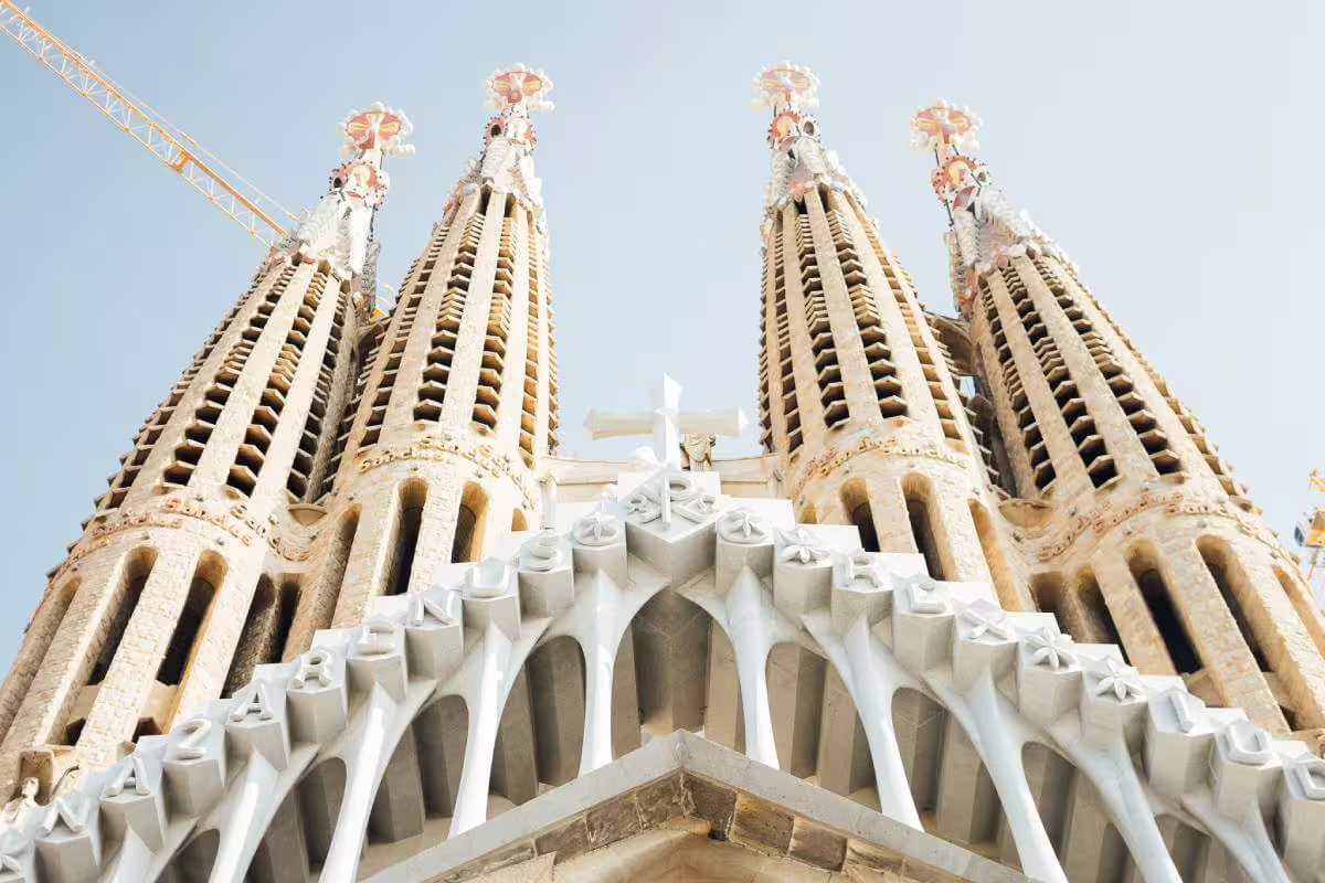 Close-up of Sagrada Familia's iconic towers against a clear sky on a skip-the-line guided tour in Barcelona.