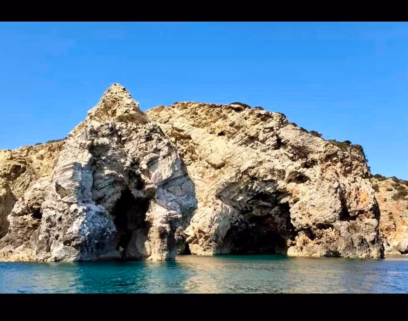 Stunning natural rock arches and sea caves along the Sagres coastline with turquoise waters on a Lagos boat tour
