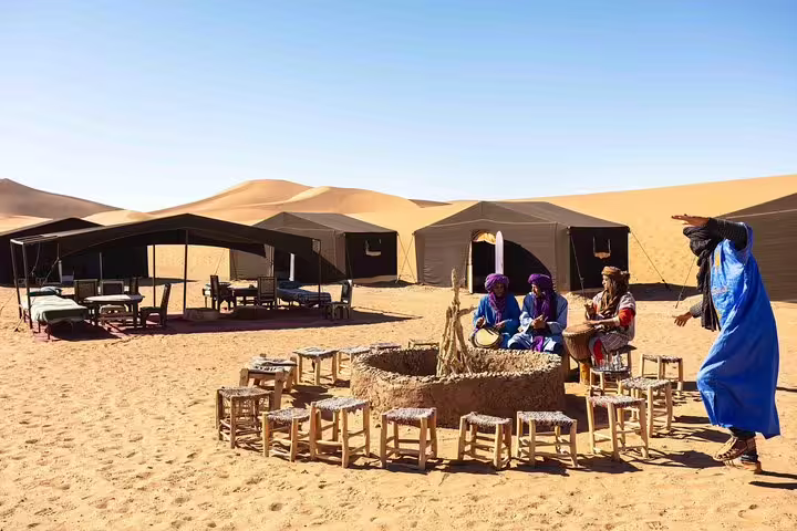 Sahara desert camp in Merzouga with Berber music by the fire, key experience on an 8-day Marrakech desert tour