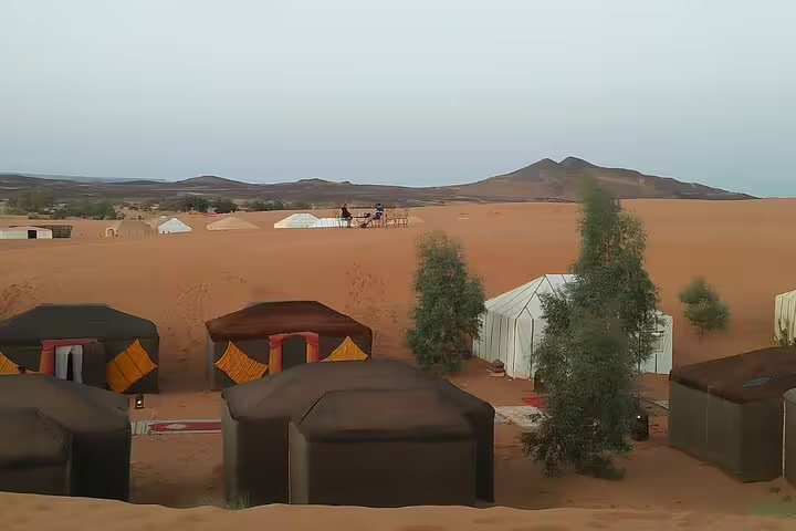 Sahara desert camp near Merzouga with luxury tents and dunes on Morocco 11-day tour from Marrakech