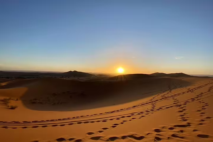 Sunrise over Erg Chebbi dunes with desert footprints, Sahara experience on 9-day Tangier to Marrakech tour