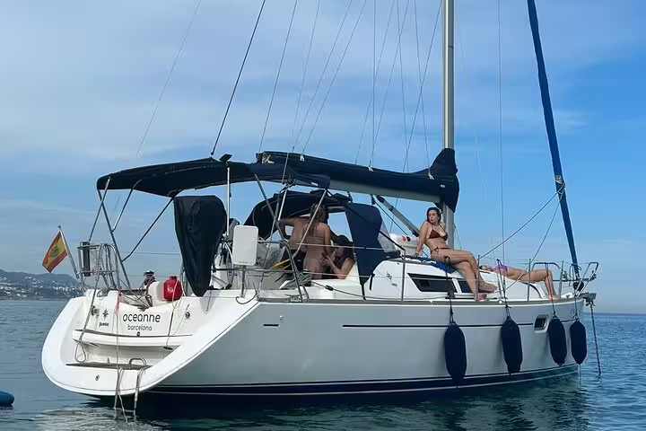 Sailboat gliding on clear waters during a private day trip to Ibiza and Formentera, offering relaxation and scenic views.