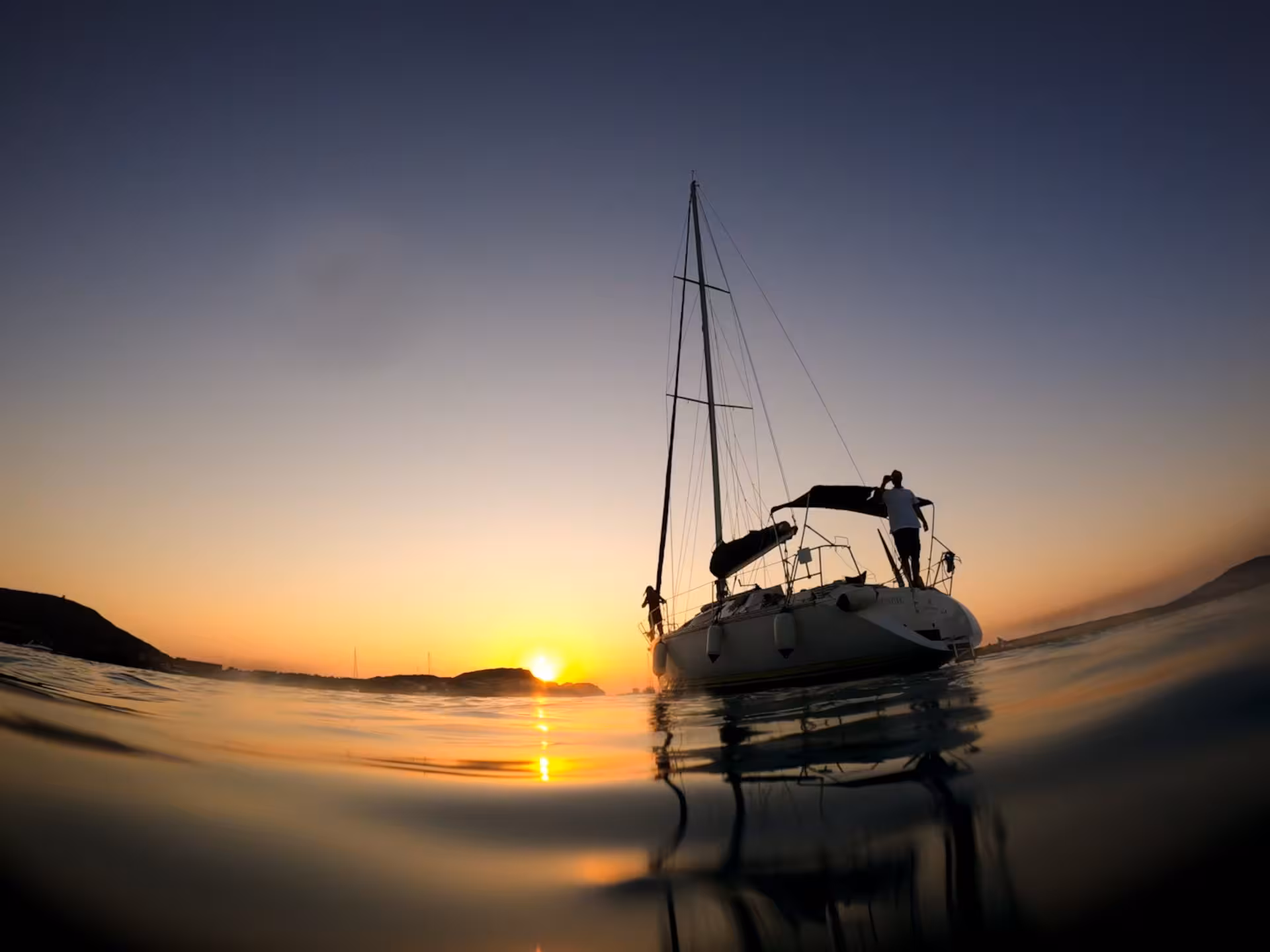 Sailing boat at sunset near Pelosa Beach, Stintino, perfect for a private aperitif experience.