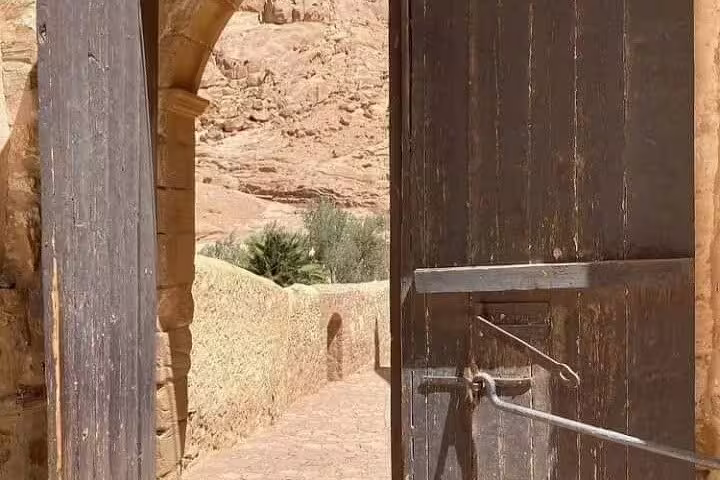 Open wooden gate and stone walkway at Saint Catherine’s Monastery, Sinai Mountains day trip from Sharm El Sheikh