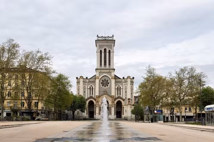 Cathedral of Saint-Etienne with fountain in foreground on an open plaza, France