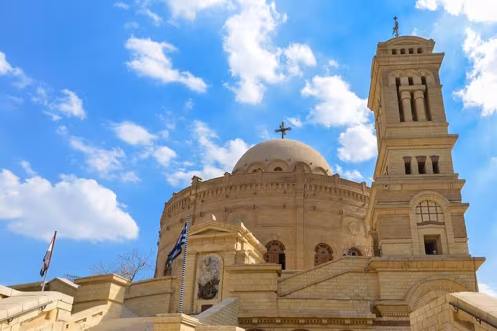 Old Cairo churches tour view of Saint George Greek Orthodox Church dome and bell tower under blue sky