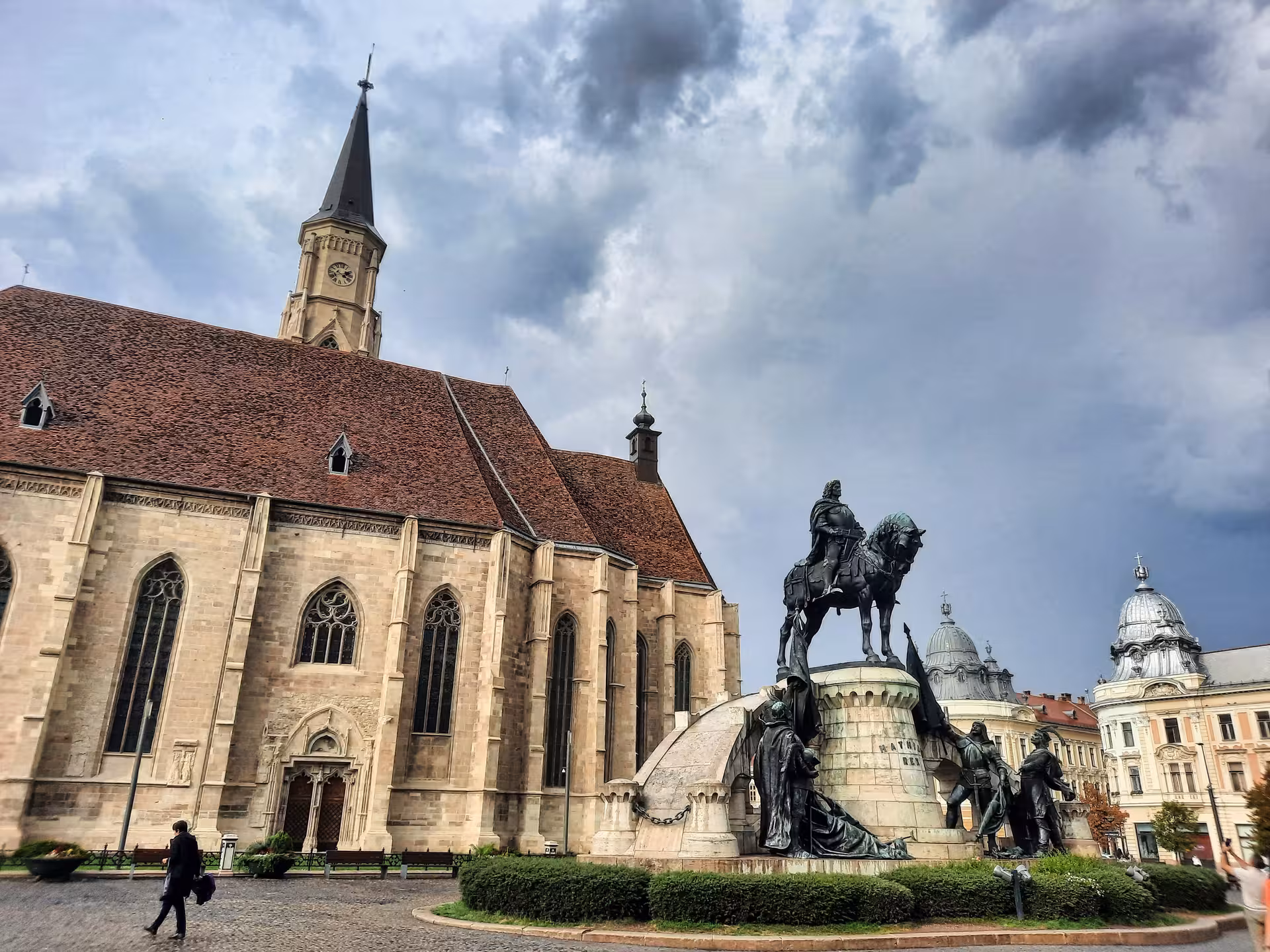 Gothic Saint Michael Church and Matthias Corvinus equestrian statue in Cluj-Napoca's historic Union Square walking tour