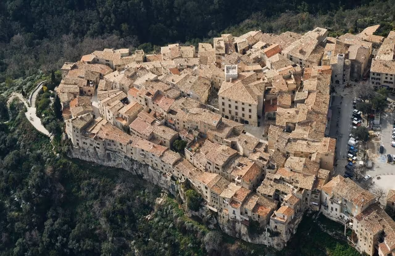 Aerial view of Saint-Paul-de-Vence medieval hilltop village with stone rooftops in Provence, France