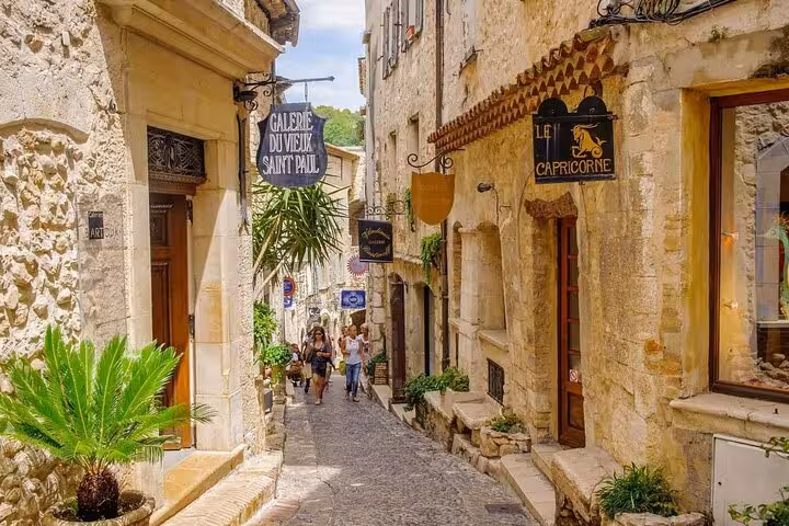 Narrow cobblestone street with art galleries and shops in Saint-Paul-de-Vence, French Riviera