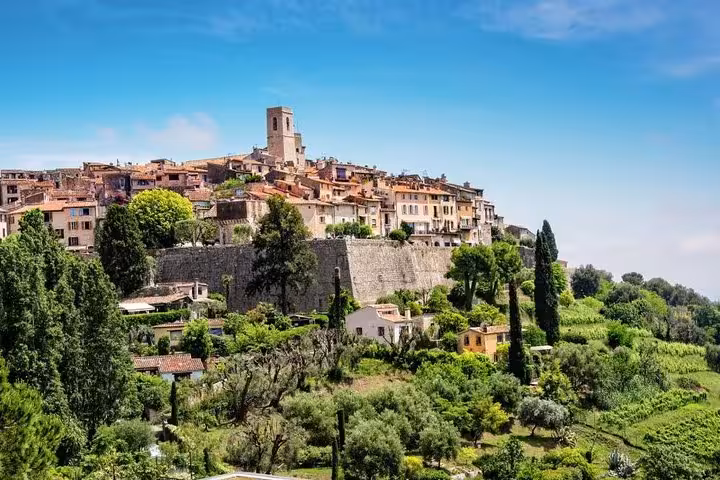 Hilltop medieval village of Saint-Paul-de-Vence with stone walls and terracotta rooftops surrounded by lush greenery