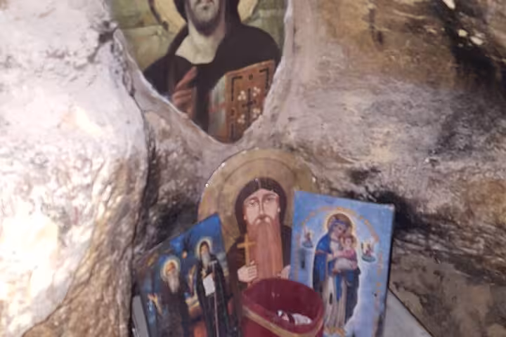 Icons and candle shrine inside Saint Paul the Anchorite Monastery cave near Hurghada, Egypt desert tour stop