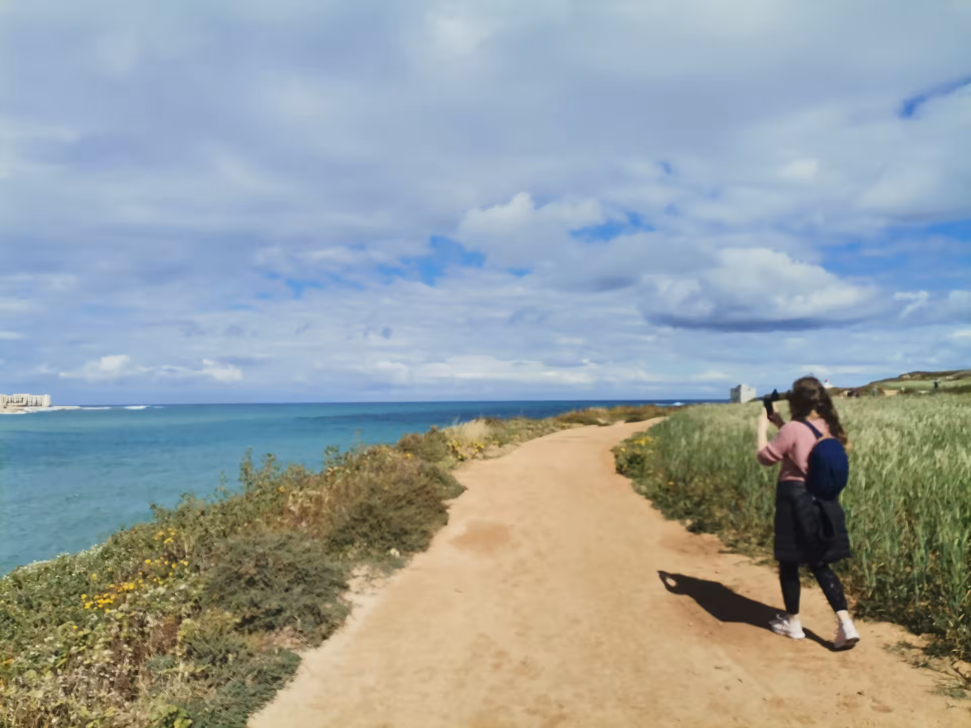 Coastal trail walk in Saint Pauls Bay, Malta, with hiker and sea views on guided hike and local picnic tour