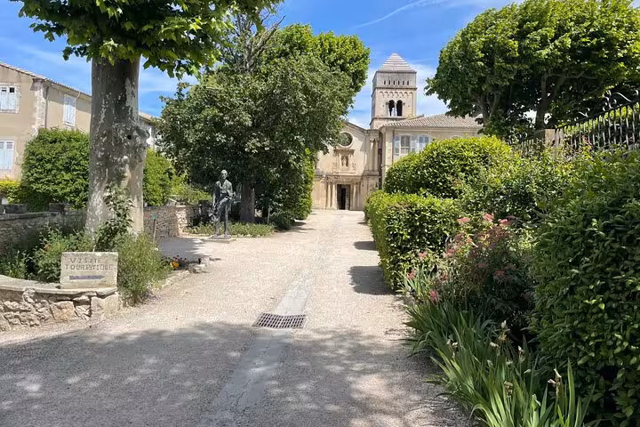 Saint-Remy-de-Provence monastery entrance path with trees and bell tower on private day trip from Arles