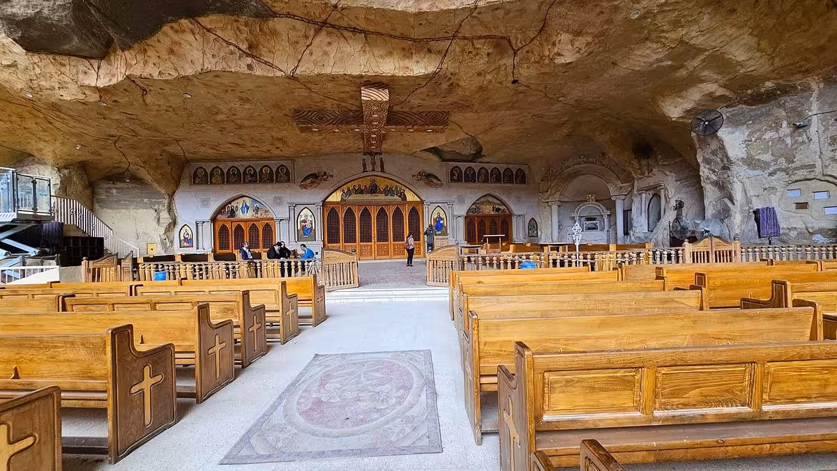 Interior of Saint Simon Cave Church with wooden pews and altar in Mokattam, Cairo, on Old Cairo tour