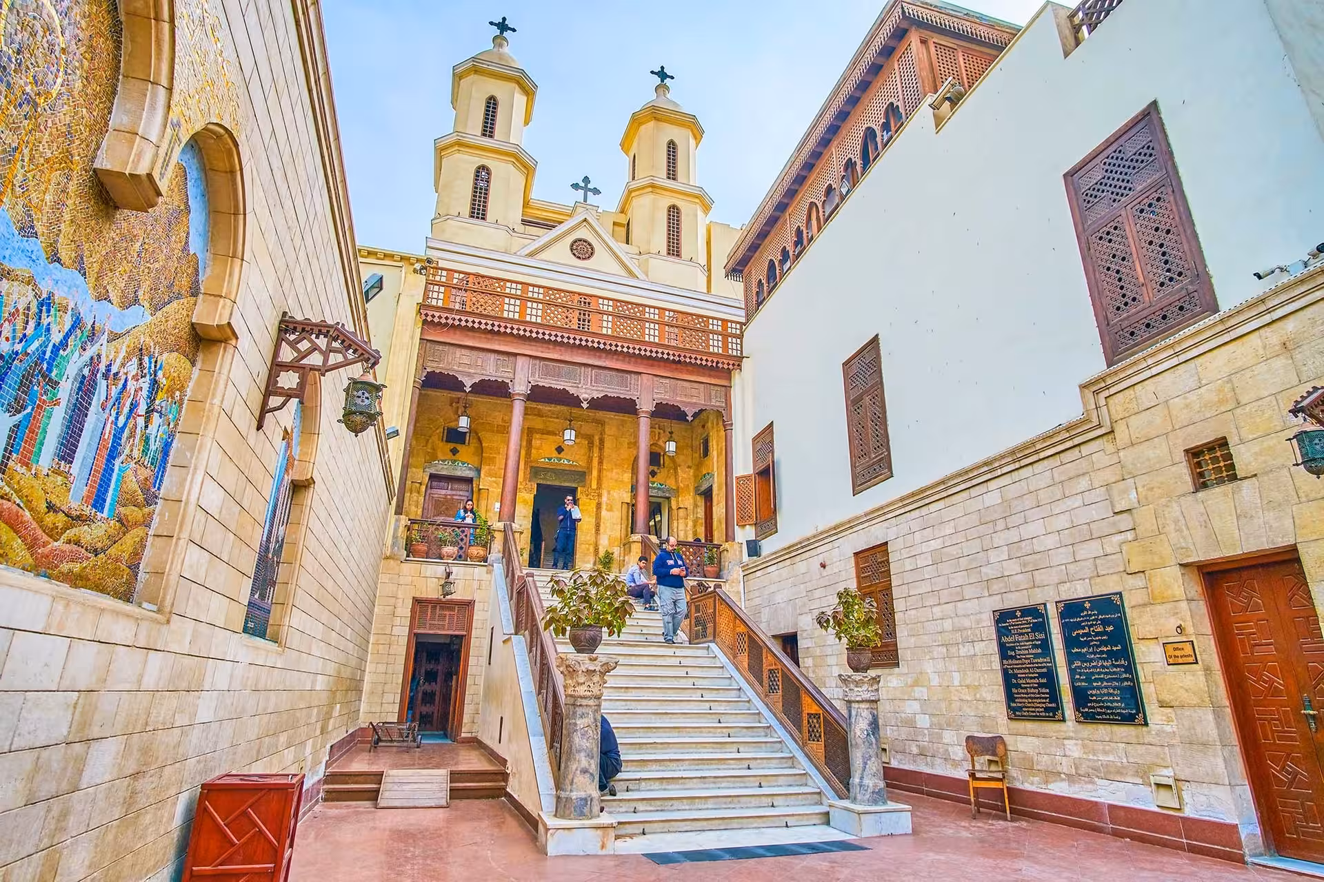 Coptic Cairo church courtyard with twin bell towers and staircase on Saint Simon monastery day tour