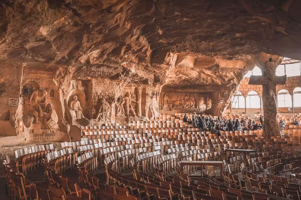 Carved stone reliefs and seating inside Saint Simon Monastery cave church, Old Cairo full-day tour