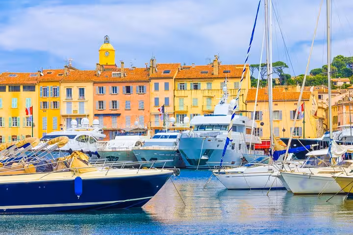Colorful waterfront buildings and luxury yachts docked in Saint-Tropez harbor on the French Riviera