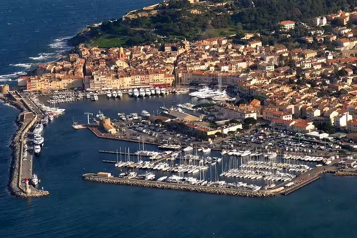 Aerial view of Saint-Tropez marina with luxury yachts and old town, highlight of Provence day trip tour