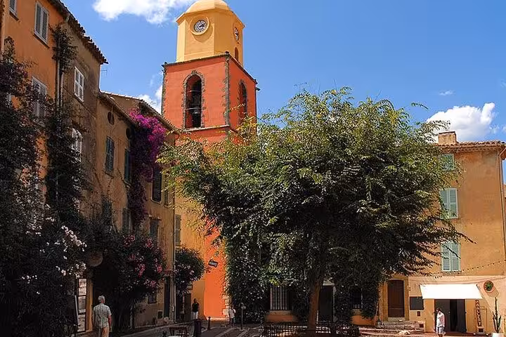 Colorful church bell tower and terracotta buildings in the old village of Saint-Tropez, French Riviera
