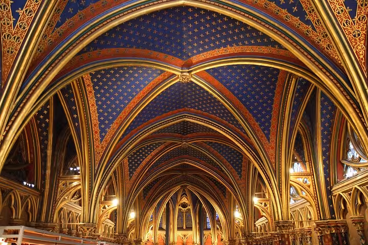 Ornate blue and gold ribbed vaulted ceiling with fleur-de-lis patterns inside Sainte-Chapelle Paris