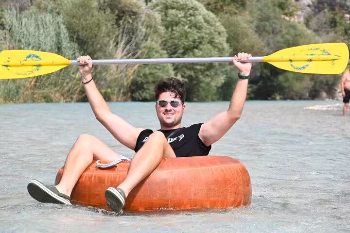 Tourist enjoying kayaking on a clear river in Saklıkent Canyon during a private guided tour from Fethiye.
