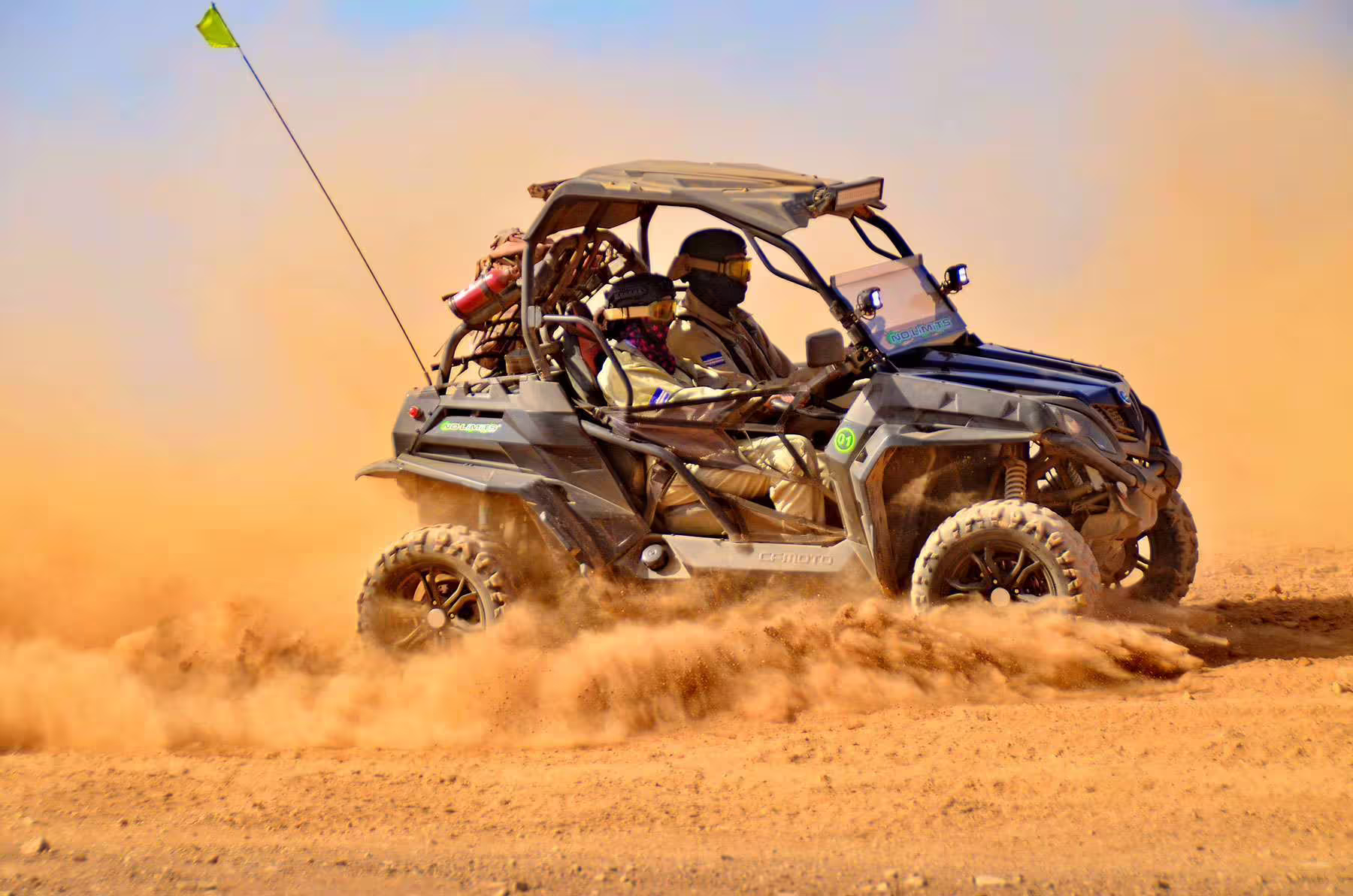 Adventurers driving a buggy through the desert sands on Sal Island's coast-to-coast 4-hour adventure tour.