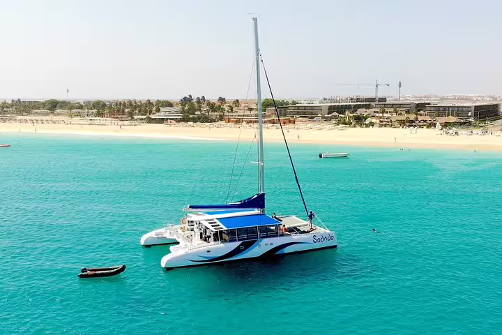 Catamaran sailing in turquoise waters near Sal Island, offering a relaxing experience with stunning coastal views.