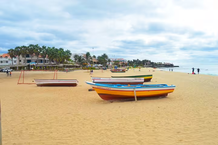 Colorful fishing boats on Santa Maria beach, Sal Island, ideal stop after airport transfer to Murdeira