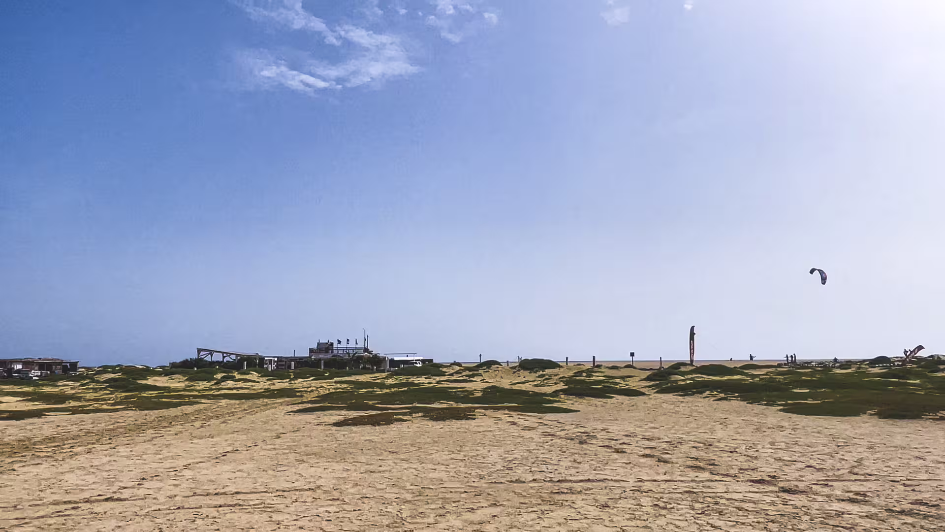 Sal Island full-day tour beach stop in Cape Verde, showing dunes, surf spot and kitesurfing near the shore