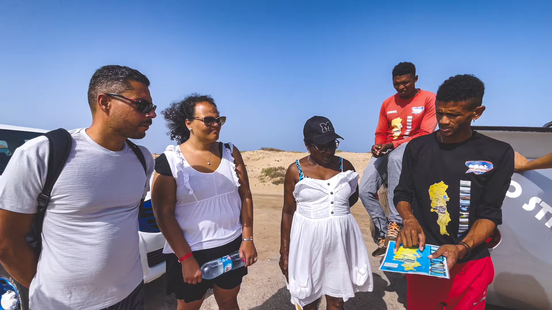 Local guide briefing travelers with map during Sal Island full-day all-inclusive tour, Cape Verde sightseeing by 4x4