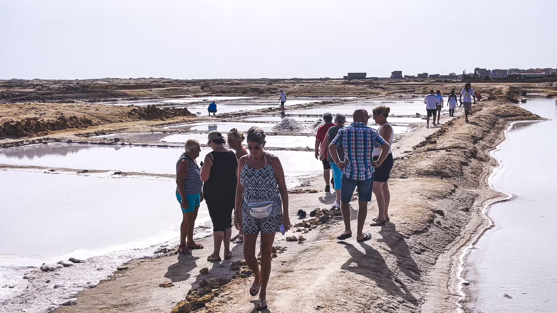 Travelers walking the Salinas de Pedra de Lume salt flats, a highlight of Sal Island full-day tour with lunch