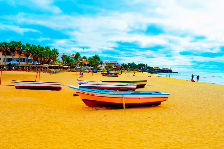 Santa Maria beach on Sal Island with colorful fishing boats, a coastal highlight after airport transfer