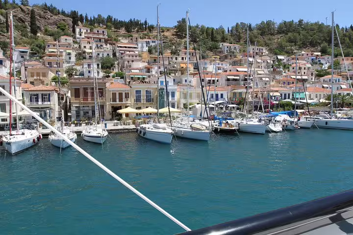 Salamina Island private tour harbor view with sailboats, waterfront cafes, and hillside village in Greece