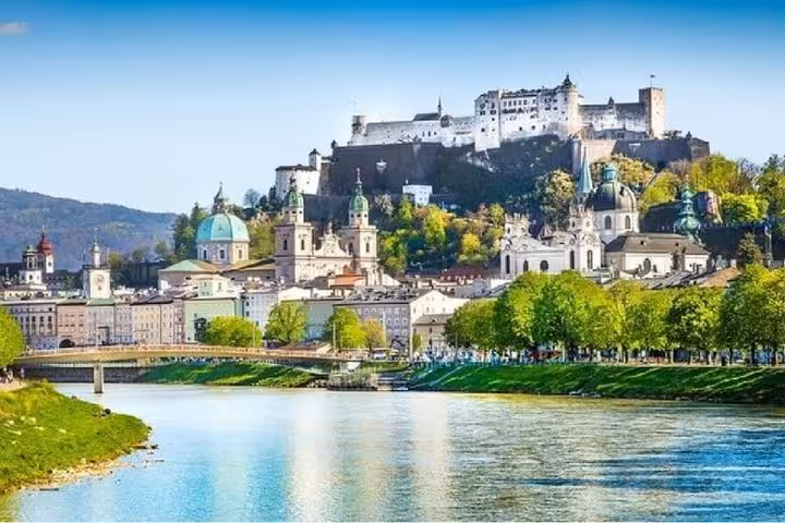 Sunny Salzburg skyline with Hohensalzburg Fortress and Salzach River, stop on Vienna to Munich transfer