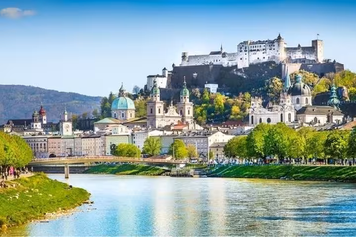 Salzburg skyline and Hohensalzburg Fortress by the Salzach River, scenic stop on Vienna to Salzburg private transfer