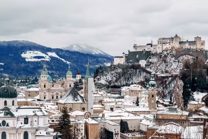Snowy Salzburg old town skyline with Hohensalzburg Fortress, winter view on Vienna to Salzburg private transfer