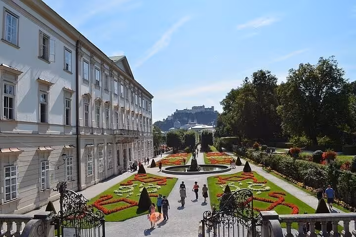 Salzburg Mirabell Gardens with flowerbeds and fortress views, scenic stop on Vienna to Munich private transfer