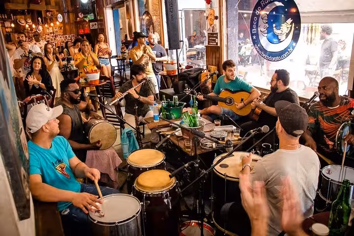 Energetic musicians playing traditional Samba instruments at a bustling Lapa venue, enhancing the authentic Rio experience.