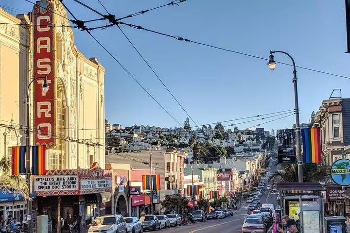 Castro Theatre marquee and rainbow flags lining Castro Street in San Francisco on a sunny day